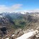 A canyon with steep walls and snow covered mountains on either side